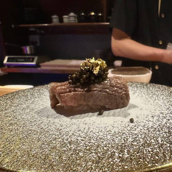Wagyu beef topped with caviar and gold flakes on a decorative plate at Yamashiro.